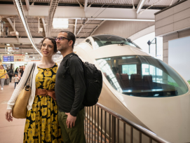 Couple bound to board the shinkansen bullet train Couple bound to board the shinkansen bullet train