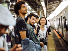 Tourists waiting to board the train, Japan Tourists waiting to board the train, Japan