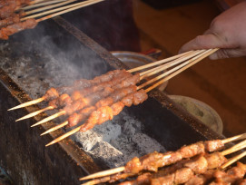 Street food stall with skewers and smoke rising from the grill in a narrow covered arcade. Image by PublicDomainPictures from Pixabay. Street food stall with skewers and smoke rising from the grill in a narrow covered arcade. Image by PublicDomainPictures from Pixabay.