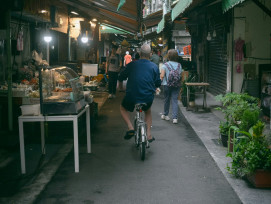 Rei cycling through a quiet Osaka backstreet lined with traditional wooden houses and small local shops.Photo by hayato togashi on Unsplash Rei cycling through a quiet Osaka backstreet lined with traditional wooden houses and small local shops.Photo by hayato togashi on Unsplash