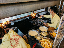 A street food stall tucked under a railway overpass, with a local vendor grilling takoyaki over a hot iron plate while a curious visitor gestures to order Photo by Markus Winkler on Unsplash A street food stall tucked under a railway overpass, with a local vendor grilling takoyaki over a hot iron plate while a curious visitor gestures to order Photo by Markus Winkler on Unsplash