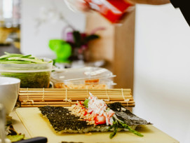 A traditional Japanese kitchen setting where a small group of participants learns precise sushi-rolling techniques from a local chef, with tea ceremony tools arranged neatly nearby Photo by Sigmund on Unsplash A traditional Japanese kitchen setting where a small group of participants learns precise sushi-rolling techniques from a local chef, with tea ceremony tools arranged neatly nearby Photo by Sigmund on Unsplash