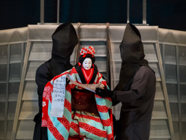 A Bunraku puppeteer in traditional attire performing on stage at the National Bunraku Theatre, with richly detailed puppets and narrators in the background. photo by 177878081 on shutterstock A Bunraku puppeteer in traditional attire performing on stage at the National Bunraku Theatre, with richly detailed puppets and narrators in the background. photo by 177878081 on shutterstock