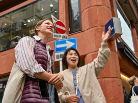 Friendly local guide leading a small group through Osaka’s lively streets Friendly local guide leading a small group through Osaka’s lively streets