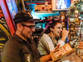 Host and guest laughing in a cozy izakaya. Host and guest laughing in a cozy izakaya.