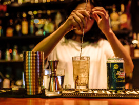 Intimate bar scene with bartender crafting cocktails. Intimate bar scene with bartender crafting cocktails.