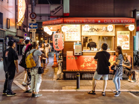 Late night street food vendor with satisfied customers