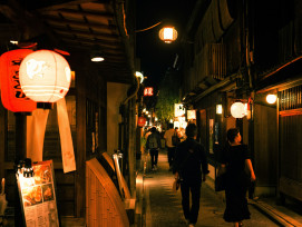 A small group walking through a quiet alley with traditional wooden buildings and lanterns.Photo by ayumi kubo on Unsplash A small group walking through a quiet alley with traditional wooden buildings and lanterns.Photo by ayumi kubo on Unsplash
