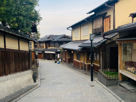 A quiet residential street in Kyoto with traditional and modern buildings side by side Photo by Shirley Wang on Unsplash
