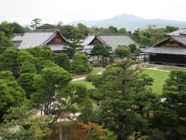 Imperial Palace gardens with traditional landscaping and distant mountains Photo by YQ Tian on Unsplash