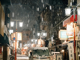 A traditional street scene with wooden buildings, warm light glowing from windows, and light snow beginning to fall Photo by Tsuyoshi Kozu on Unsplash A traditional street scene with wooden buildings, warm light glowing from windows, and light snow beginning to fall Photo by Tsuyoshi Kozu on Unsplash