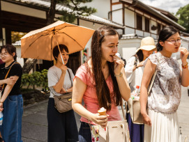 Candid shot of traveler and host chatting over lunch in Kyoto Candid shot of traveler and host chatting over lunch in Kyoto