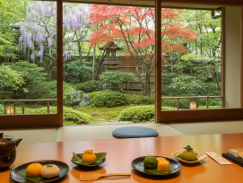 Traditional tea house interior with garden view and seasonal sweets display Traditional tea house interior with garden view and seasonal sweets display
