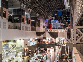 Modern Kyoto Station interior with traditional craft shops and evening lighting Modern Kyoto Station interior with traditional craft shops and evening lighting
