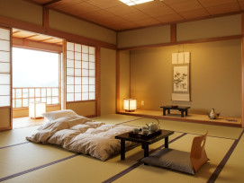 A traditional ryokan room with tatami mats, futon bedding, and sliding paper doors A traditional ryokan room with tatami mats, futon bedding, and sliding paper doors