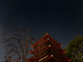 Temple pagoda illuminated against star-filled November sky Photo by Iori Ikeda on Unsplash