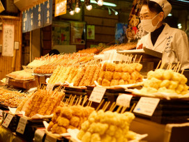 A vendor at Nishiki Market preparing traditional Japanese sweets with customers watching the process Photo by Stefan Schwinghammer on Unsplas A vendor at Nishiki Market preparing traditional Japanese sweets with customers watching the process Photo by Stefan Schwinghammer on Unsplas