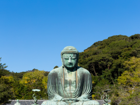 Great Buddha statue with trees in the background