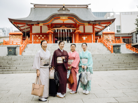People standing in front of a temple in Tokyo, Japan