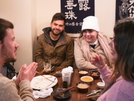 Travelers enjoying Japanese food