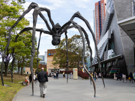 Tourist walking under a art piece, Mori Art Museum
