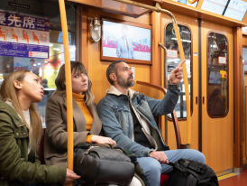 Tourists on public transport in Tokyo, Japan