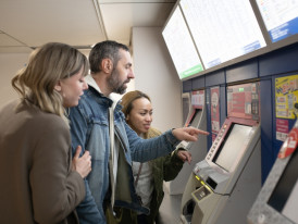 Tourists learning how to navigate the Tokyo from a loca
