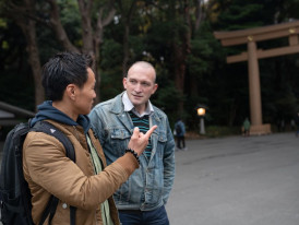 Two men standing in front of shrine