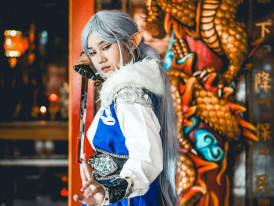 Traditional temple behind someone posing in cosplay. Image by murod podolsky from pexels.