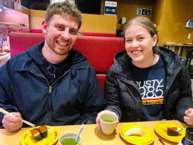 Host and guest chatting in a laneway café