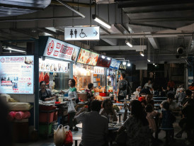 Busy underground food court near Osaka Station with multiple vendors.Photo by Cameorn Steele on Unsplash