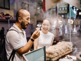 Respectful interaction between foreign visitors and local food vendors.