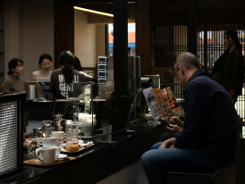 Local businessman reading newspaper at small café in Osaka city center. Image by inyoung jung from Unsplash