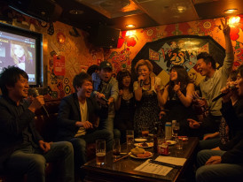 Friends singing karaoke late at night.