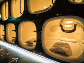 Modern capsule hotel pod interior.