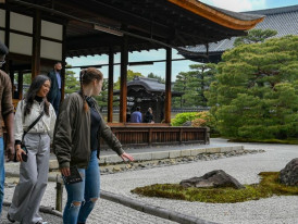 Tourists crowded around famous Kyoto temple taking photos.