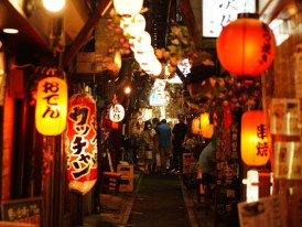 Guests navigating a small passageway between street food stalls.