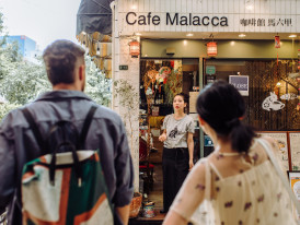 Guests and a host planning a route at a café.