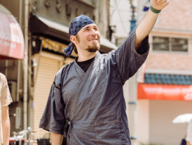 A guide sharing cultural insights while pointing to architectural details.