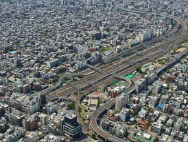 Aerial view of Osaka's organized street grid with train lines visible.