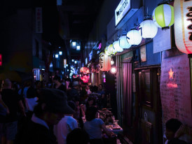 Namba's neon-lit streets with crowds of people shopping and eating Photo by Alex Knight on Unsplash