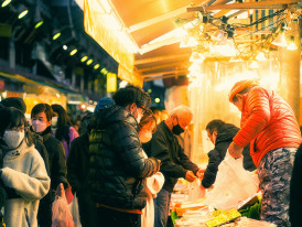 Winter scene in Osaka with people enjoying hot street food Photo by ayumi kubo on Unsplash