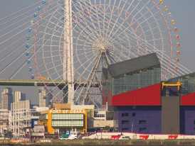 Large Ferris wheel at Tempozan Harbor Village with bay and ships visible.