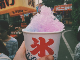 Locals cooling off with shaved ice at a street vendor Photo by Saya Kimura on pexels