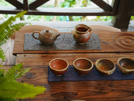 Traditional tea ceremony setup with summer elements Photo by haijiang zeng on Unsplash