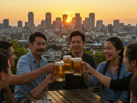 Groups toasting with beer mugs at outdoor tables