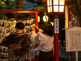 Small neighborhood shrine with local residents offering prayers during ceremony. Photo by Kouji Tsuru on Unsplash