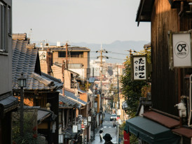 Quiet residential street in Kyoto showing traditional houses and daily life. Photo by Daisy Chen on Unsplash