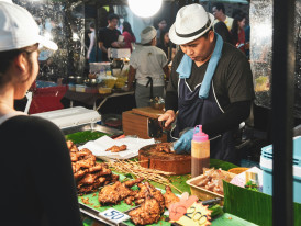 Busy Osaka street food market with vendors preparing local specialties Photo by Bao Menglong on Unsplash
