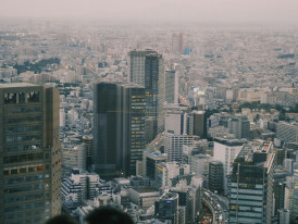 Traveler contemplating different cultural experience options while viewing city panorama. Photo by Haotian Zheng on Unsplash